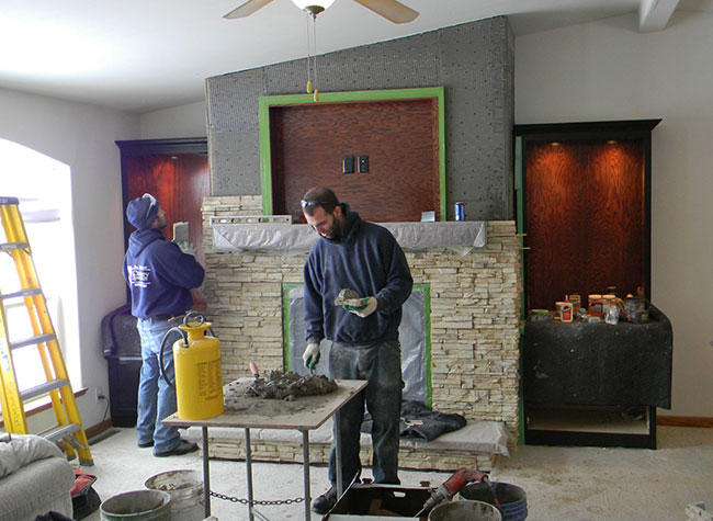 Professionals with freshly installed fireplace in Cuba City WI