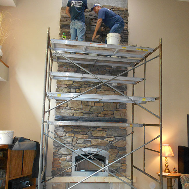 Baraboo Wi chimney specialists working on fireplace