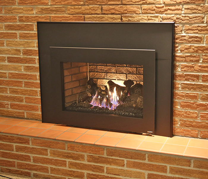 couple with gas fireplace insert in madison wi